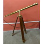 A brass telescope on tripod stand