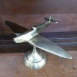 A brass model of a spitfire on stand