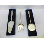 A continental white metal cake slice and a pair of silver plated servers