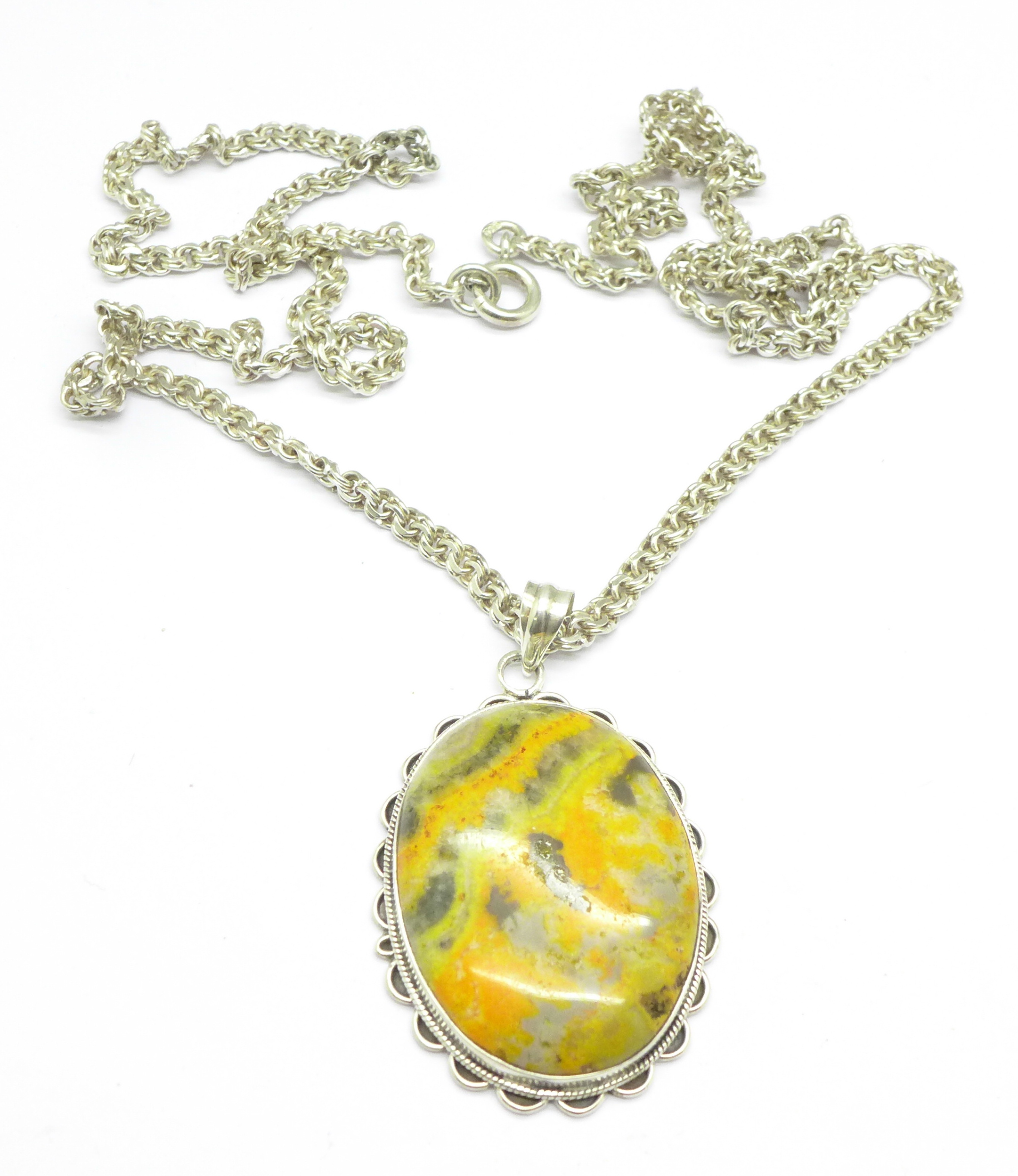 A silver, agate set pendant on a long silver chain,