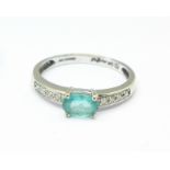 A 9ct white gold, apatite set ring with diamond shoulders, 1.