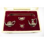 A hallmarked silver miniature four piece tea service with tray, tray 14.