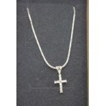 A small 18ct gold and diamond cross with a chain