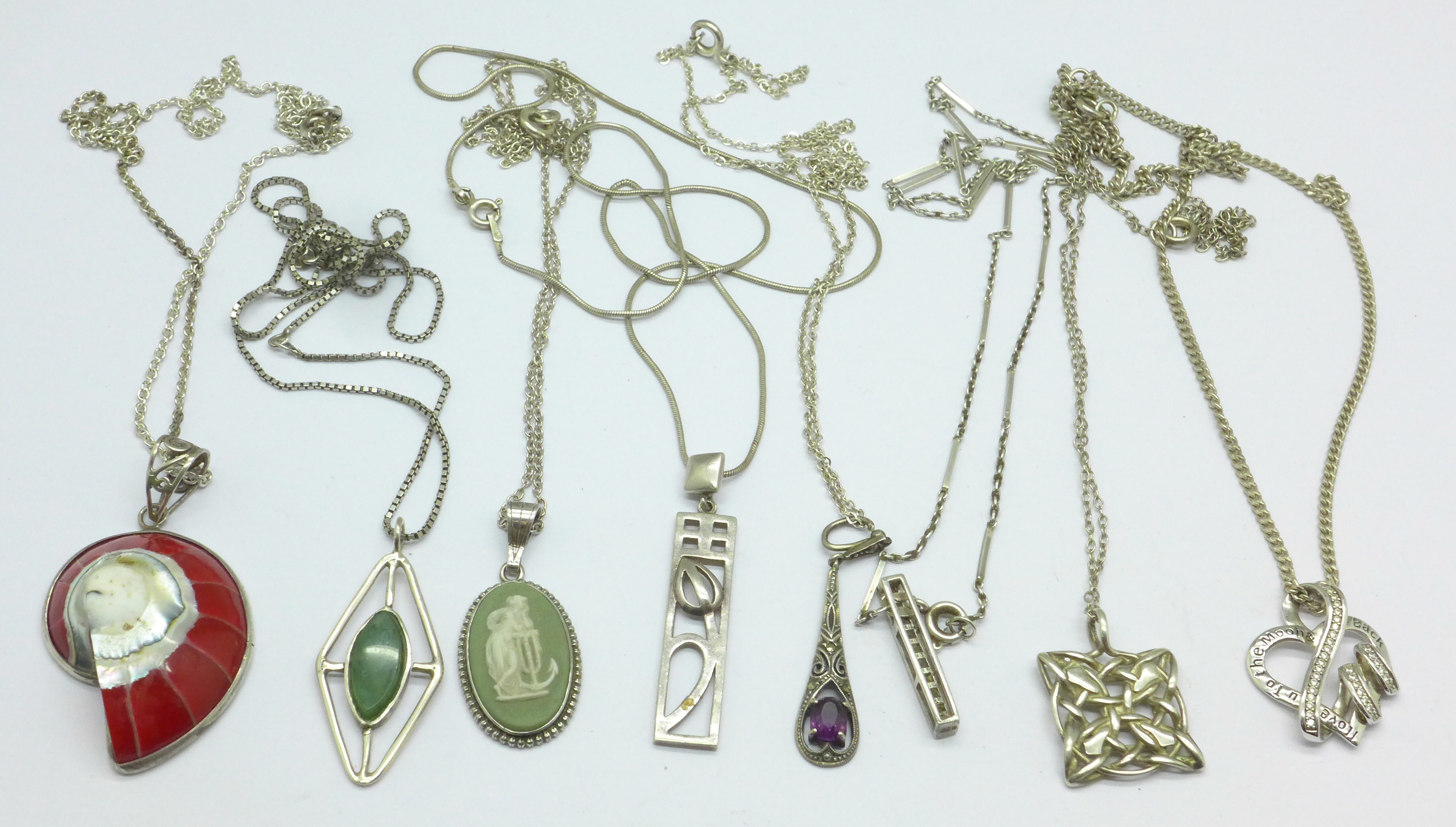 Eight silver pendants and chains