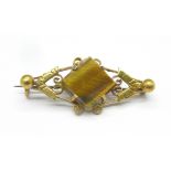 A yellow metal and tigers eye brooch, 4.