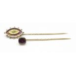 Two yellow metal stick pins, one set with an old cut diamond and one set with a garnet, 5.