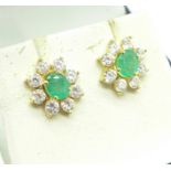 A pair of ear studs set with emeralds and white stones,