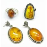A pair of amber earrings and two amber rings