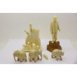 A carved ivory diorama, three carved ivory elephants and a carved ivory figure of a gentleman,