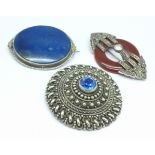 Three large silver mounted brooches