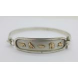 A gold applied silver bangle,