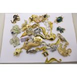 A collection of brooches including sea horses and elephants