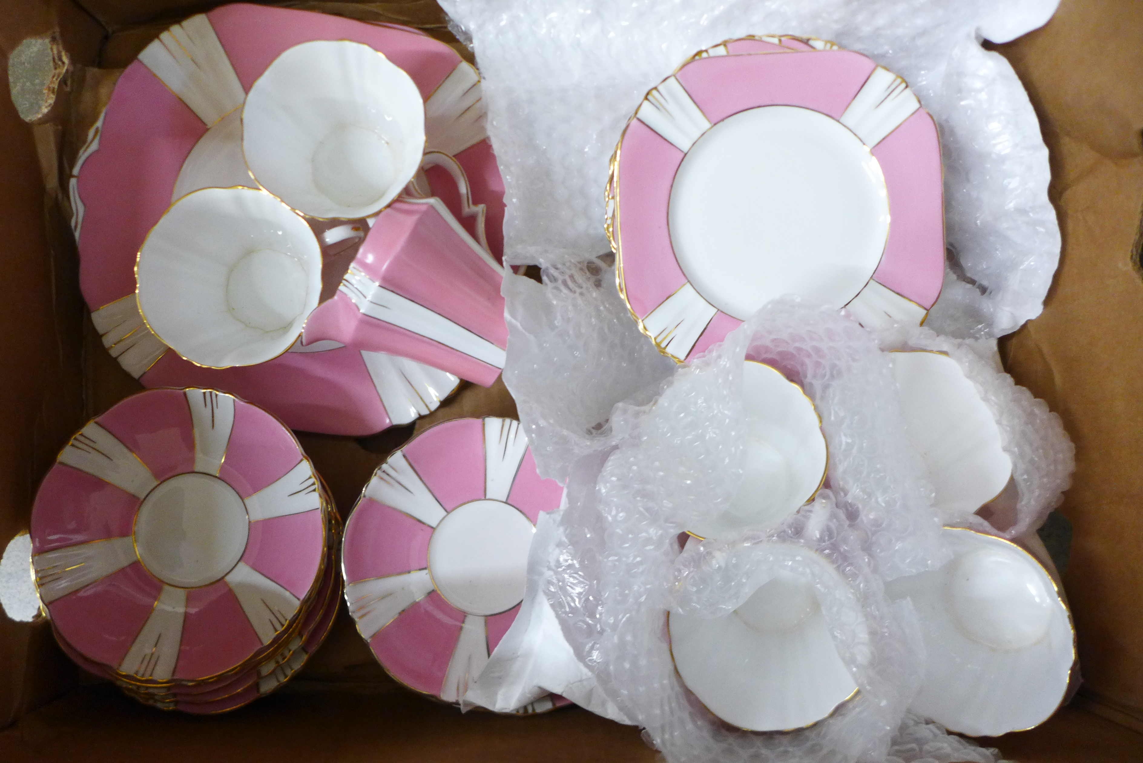 Royal Albert Art Deco teaware in pink and white, (six cups, ten saucers, twelve side plates,