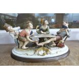 A Capodimonte group figure of boys playing cards, signed B.
