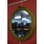 A Victorian gilt gesso framed oval mirror