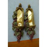 A pair of grape framed hall mirrors