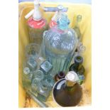 Two soda water bottles, a large Poison bottle and other bottles including Toscano wine bottle,