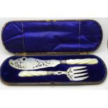 Victorian silver and mother of pearl handled fish servers, the blade decorated with fishing scene,