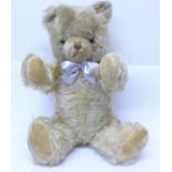 A mohair Teddy bear with growler, fully jointed with glass eyes and velvet pads,