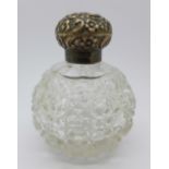 A globular silver topped scent bottle