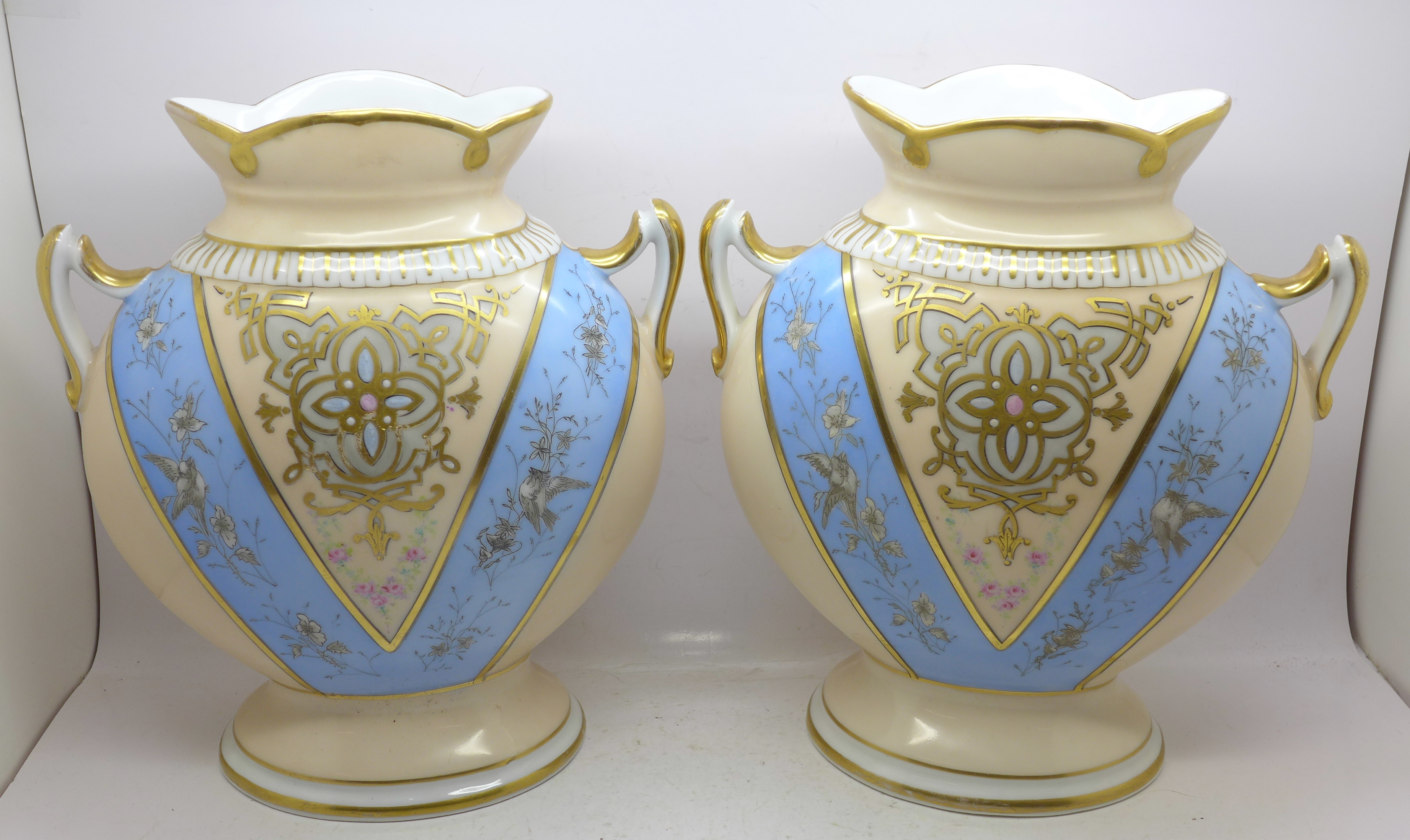 A pair of continental two handled vases