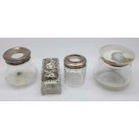 Four silver topped glass jars,