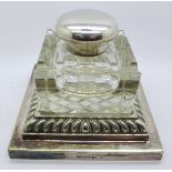 A large, heavy silver plate and glass inkwell, by Walker & Hall,