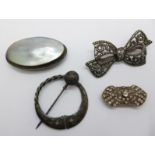 An Iona silver penannular brooch and three other brooches
