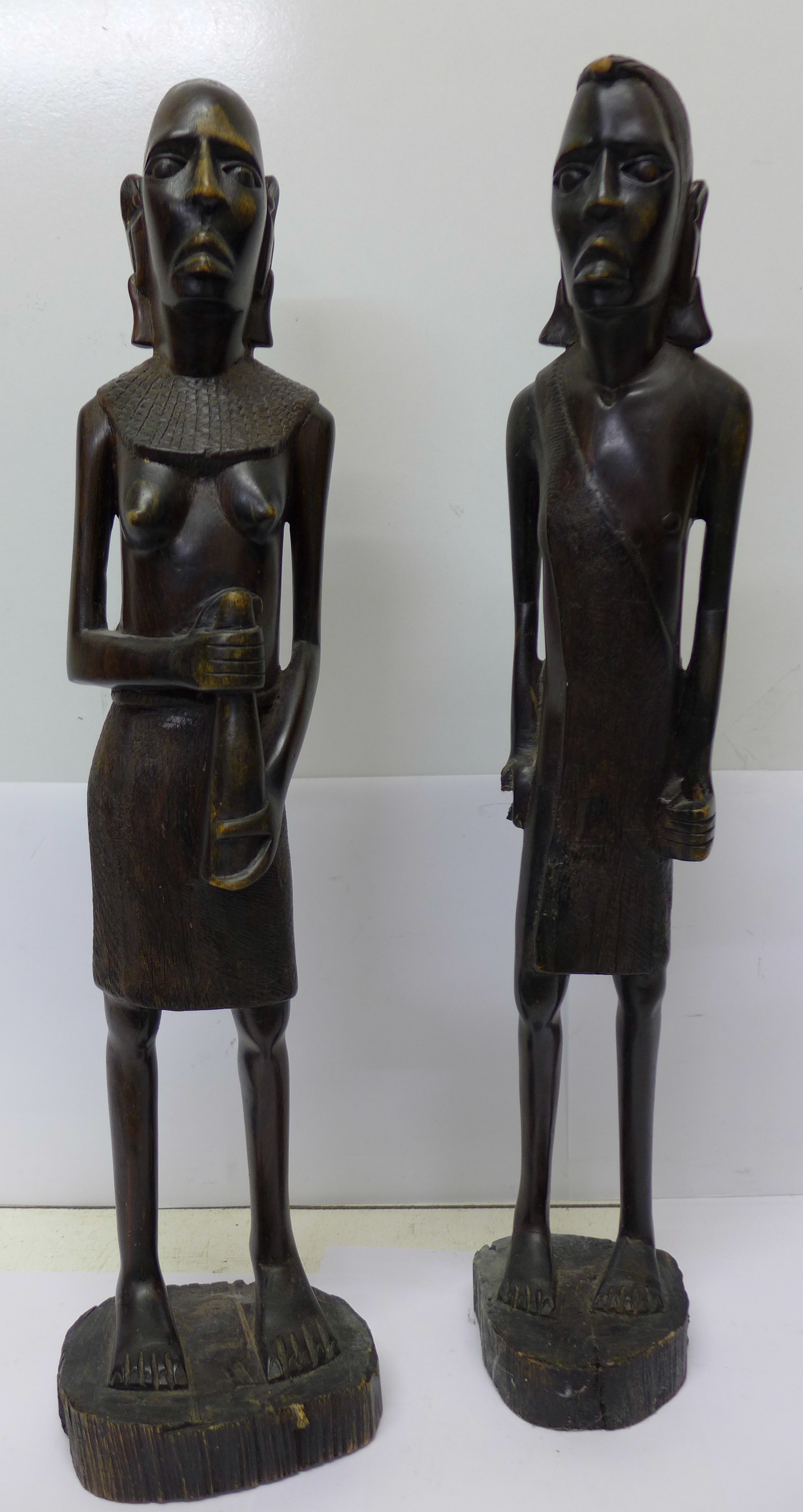 A pair of carved wood African figures,