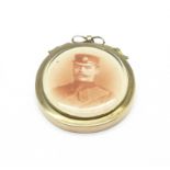 A yellow metal mounted photograph pendant,