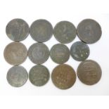 Twelve assorted old bronze tokens