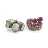 A silver three stone ring and a red stone set ring, tests as silver,