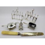 Two silver toast racks, a three piece silver set, a/f,