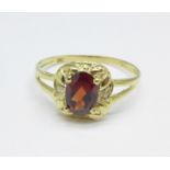 A 9ct gold, red stone and diamond ring, 1.