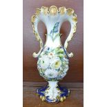 A two handled vase decorated with flowers, one handle restored and cracked, petals a/f, 34.