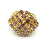 A large 9ct gold garnet set cocktail ring, 7.