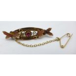 A 9ct gold and red stone brooch,