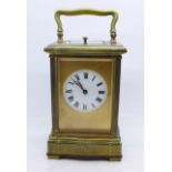 A brass repeater carriage clock, enamel dial, movement signed Paris, 14cm,