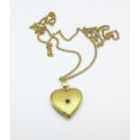 A plated heart locked on a 9ct gold chain,