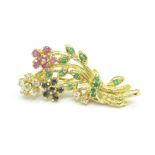 A silver gilt brooch set with rubies, emeralds,