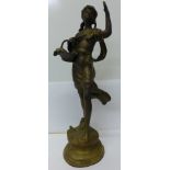 A brass figure of a girl holding a basket,