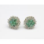 A pair of emerald and diamond ear studs set in 9ct gold