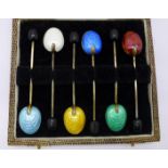A cased set of six silver and enamel coffee bean spoons, enamel a/f on three,