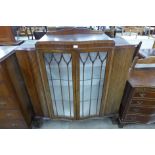 A mahogany serpentine display cabinet