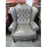 A mahogany and mauve leather wingback armchair