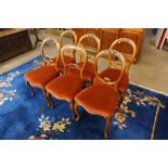 A Harlequin set of six Victorian walnut balloon back dining chairs