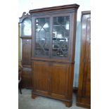 A George III oak freestanding splay front corner cupboard