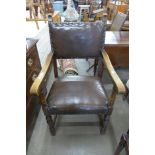 An oak and brown leather armchair