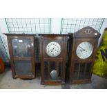 Two oak wall clocks and a case with movement