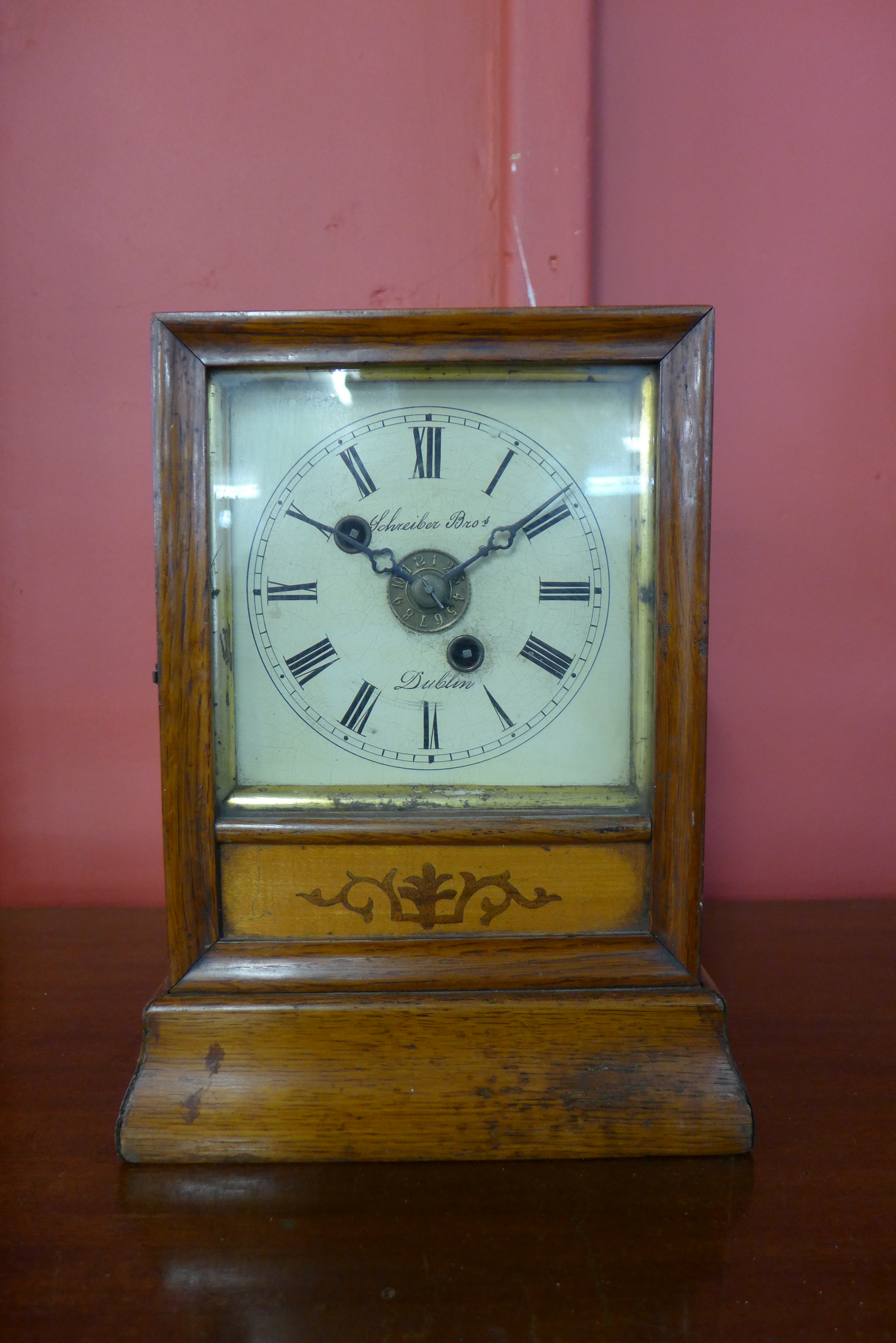 A 19th Century Irish inlaid oak mantel clock, the dial signed Schreiber Bros,